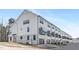 Modern townhome exterior featuring light siding, dark framed windows, and individual garage entries at 324 Church St, Morrisville, NC 27560