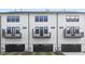 Modern townhome featuring balconies, dark garage doors and well kept landscaping at 324 Church St, Morrisville, NC 27560