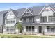 Charming townhome featuring a stone foundation and an attractive front lawn at 324 Church St, Morrisville, NC 27560