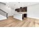 Modern kitchen with stainless appliances, central island, stylish cabinets, and hardwood flooring at 324 Church St, Morrisville, NC 27560