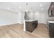 Bright kitchen featuring a central island with stainless appliances, and hardwood flooring at 324 Church St, Morrisville, NC 27560