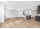 Spacious living area featuring an open kitchen, hardwood floors, and recessed lighting at 324 Church St, Morrisville, NC 27560