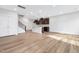 Spacious living area featuring an open kitchen, hardwood floors, and recessed lighting at 324 Church St, Morrisville, NC 27560