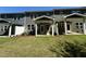 View of townhome backyards with green grass and covered patios, perfect for relaxing outdoors at 622 Brittany Ct, Durham, NC 27703