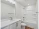 Bathroom featuring a single sink vanity, bathtub with shower, white cabinets, and wood-look flooring at 622 Brittany Ct, Durham, NC 27703