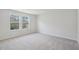 Bright bedroom featuring plush carpeting and large windows for ample natural light at 622 Brittany Ct, Durham, NC 27703
