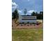 Tredenham community sign with brick base and landscaping, welcoming residents and visitors at 622 Brittany Ct, Durham, NC 27703