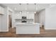 Modern kitchen featuring a center island, white cabinetry, stainless steel appliances, and wood-look flooring at 622 Brittany Ct, Durham, NC 27703