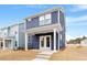 Two-story home with a covered patio and steps to the back yard and lawn at 672 Georgia'S Landing Pkwy # 69, Raleigh, NC 27603