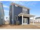 New two-story home with blue siding, white trim, and a covered patio at 672 Georgia'S Landing Pkwy # 69, Raleigh, NC 27603