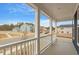 Charming front porch with white railing and pillars overlooking the neighborhood at 672 Georgia'S Landing Pkwy # 69, Raleigh, NC 27603