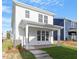 Exterior rear view of a home with a covered porch, showcasing its backyard space and design at 716 Georgias Landing Pkwy # 12, Raleigh, NC 27603