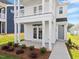 Close up view of a charming two-story home with a double porch, showcasing its inviting entrance at 716 Georgias Landing Pkwy # 12, Raleigh, NC 27603