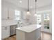 Modern kitchen featuring white cabinets, stainless steel appliances, and a center island at 716 Georgias Landing Pkwy # 12, Raleigh, NC 27603