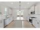Bright kitchen with white cabinets, stainless steel appliances, and a center island with quartz countertops at 716 Georgias Landing Pkwy # 12, Raleigh, NC 27603