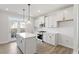 Modern kitchen featuring white cabinetry, stainless steel appliances, and a center island with seating at 716 Georgias Landing Pkwy # 12, Raleigh, NC 27603