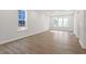 Bright, spacious living room with gleaming hardwood floors and large windows at 716 Georgias Landing Pkwy # 12, Raleigh, NC 27603