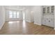 Open-concept living area with hardwood floors, natural light, and built in cabinets at 716 Georgias Landing Pkwy # 12, Raleigh, NC 27603