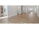 Expansive living area showing hardwood floors, neutral walls, leading to the kitchen and dining spaces at 716 Georgias Landing Pkwy # 12, Raleigh, NC 27603