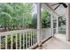 Relaxing back porch with white railings, offering serene views of the surrounding wooded landscape at 1620 Dunn Rd, Raleigh, NC 27614