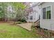 The backyard has a patio, grass, and trees that provide a scenic view at 1620 Dunn Rd, Raleigh, NC 27614