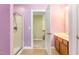 Bathroom with shower, double vanity, and access to hallway at 1620 Dunn Rd, Raleigh, NC 27614