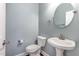 Clean bathroom with pedestal sink and oval mirror at 1620 Dunn Rd, Raleigh, NC 27614
