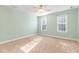 Light-filled bedroom with neutral walls and carpet flooring at 1620 Dunn Rd, Raleigh, NC 27614