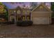 Two-story house with stone accents, large windows, and a two-car garage at 1620 Dunn Rd, Raleigh, NC 27614