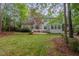 Back exterior view of a two-story home from a well-manicured backyard and patio area at 1620 Dunn Rd, Raleigh, NC 27614