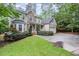 Charming two-story home boasts a stone and siding exterior, landscaped lawn, and an attached two-car garage at 1620 Dunn Rd, Raleigh, NC 27614