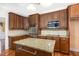 Island kitchen with granite countertops and stainless steel appliances at 1620 Dunn Rd, Raleigh, NC 27614