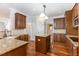 Open kitchen with granite island and hardwood floors at 1620 Dunn Rd, Raleigh, NC 27614