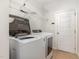 Bright laundry room, washer, dryer, and ample shelving at 1620 Dunn Rd, Raleigh, NC 27614