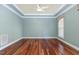 Inviting living room featuring crown molding, hardwood floors, and abundant natural light through a large window at 1620 Dunn Rd, Raleigh, NC 27614