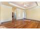 A generous main bedroom showcases hardwood floors, tray ceilings, ceiling fan, and access to a private ensuite bathroom at 1620 Dunn Rd, Raleigh, NC 27614
