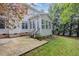An outdoor patio with a connecting sunroom, grass and a well-maintained landscape at 1620 Dunn Rd, Raleigh, NC 27614