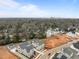 An aerial view of the neighborhood, featuring the new construction home, with the city skyline in the background at 2642 Marchmont St, Raleigh, NC 27608