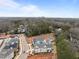 An aerial view of the neighborhood shows a new construction home, surrounding trees, and city skyline at 2642 Marchmont St, Raleigh, NC 27608
