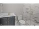 Bathroom with modern fixtures, marble countertops, and tiled shower at 2642 Marchmont St, Raleigh, NC 27608