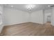Bright bedroom features wood floors, a modern chandelier, neutral walls, and closet access at 2642 Marchmont St, Raleigh, NC 27608
