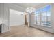 Bright dining room with hardwood floors, modern chandelier, and large windows at 2642 Marchmont St, Raleigh, NC 27608