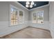 Bright dining room boasts large windows, hardwood floors, and elegant trim at 2642 Marchmont St, Raleigh, NC 27608