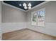 Elegant dining room featuring wainscoting, hardwood floors, and a modern chandelier at 2642 Marchmont St, Raleigh, NC 27608