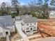 An aerial view of the new construction brick home with a grey shingle roof and a long driveway at 2642 Marchmont St, Raleigh, NC 27608