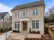 Charming two-story brick home with large windows and a welcoming front entrance at 2642 Marchmont St, Raleigh, NC 27608