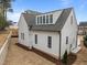 Rear exterior view of a two-story home showcasing architectural design and landscaping potential at 2642 Marchmont St, Raleigh, NC 27608