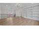 Hallway featuring wood floors, and a view of the second story with a dark railing at 2642 Marchmont St, Raleigh, NC 27608