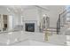 Spacious kitchen featuring a large island with marble countertops, stainless steel faucet, and adjacent living area at 2642 Marchmont St, Raleigh, NC 27608