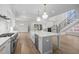 Open concept kitchen and living area with a large center island and stainless appliances at 2642 Marchmont St, Raleigh, NC 27608